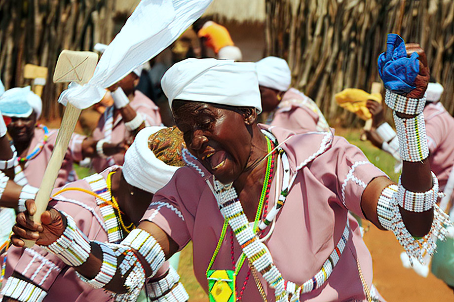 Princess Mabjalwa Modika dancing in pink dress, white head wrap and beadwork